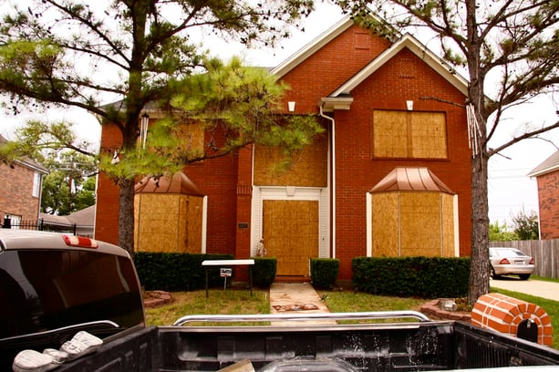 Windows boarded up with plywood for Hurricane Ike