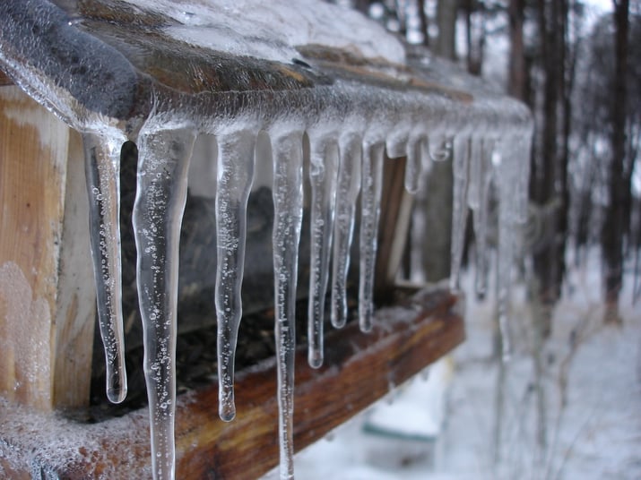 icicles ice dam on home roof gutter