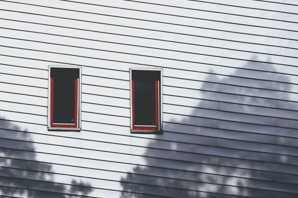 white-siding-and-two-windows-on-house