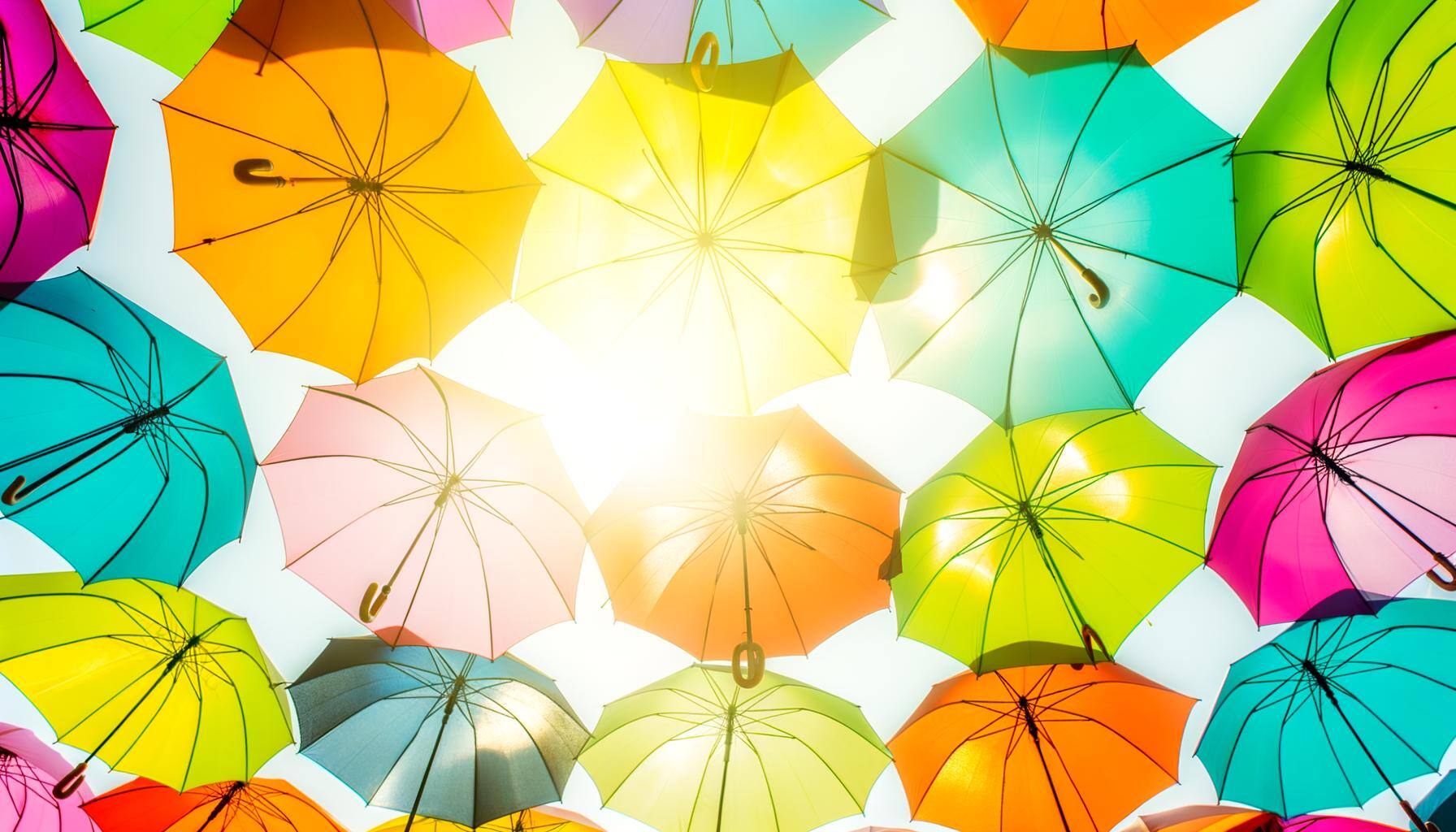 Colorful umbrellas with sun shining through