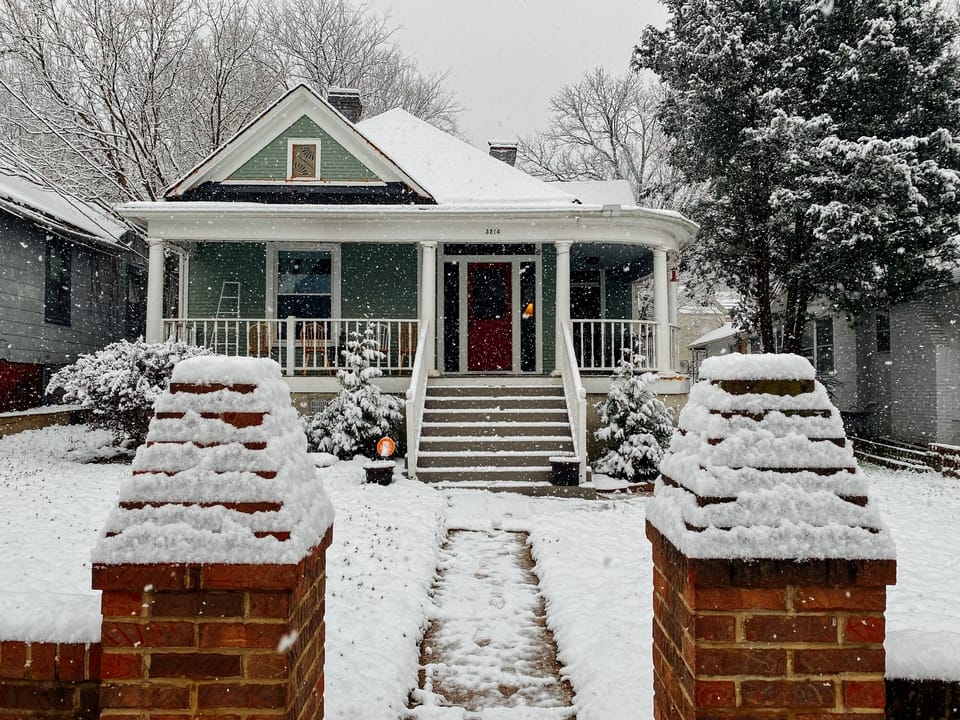 green-and-white-house-in-snow