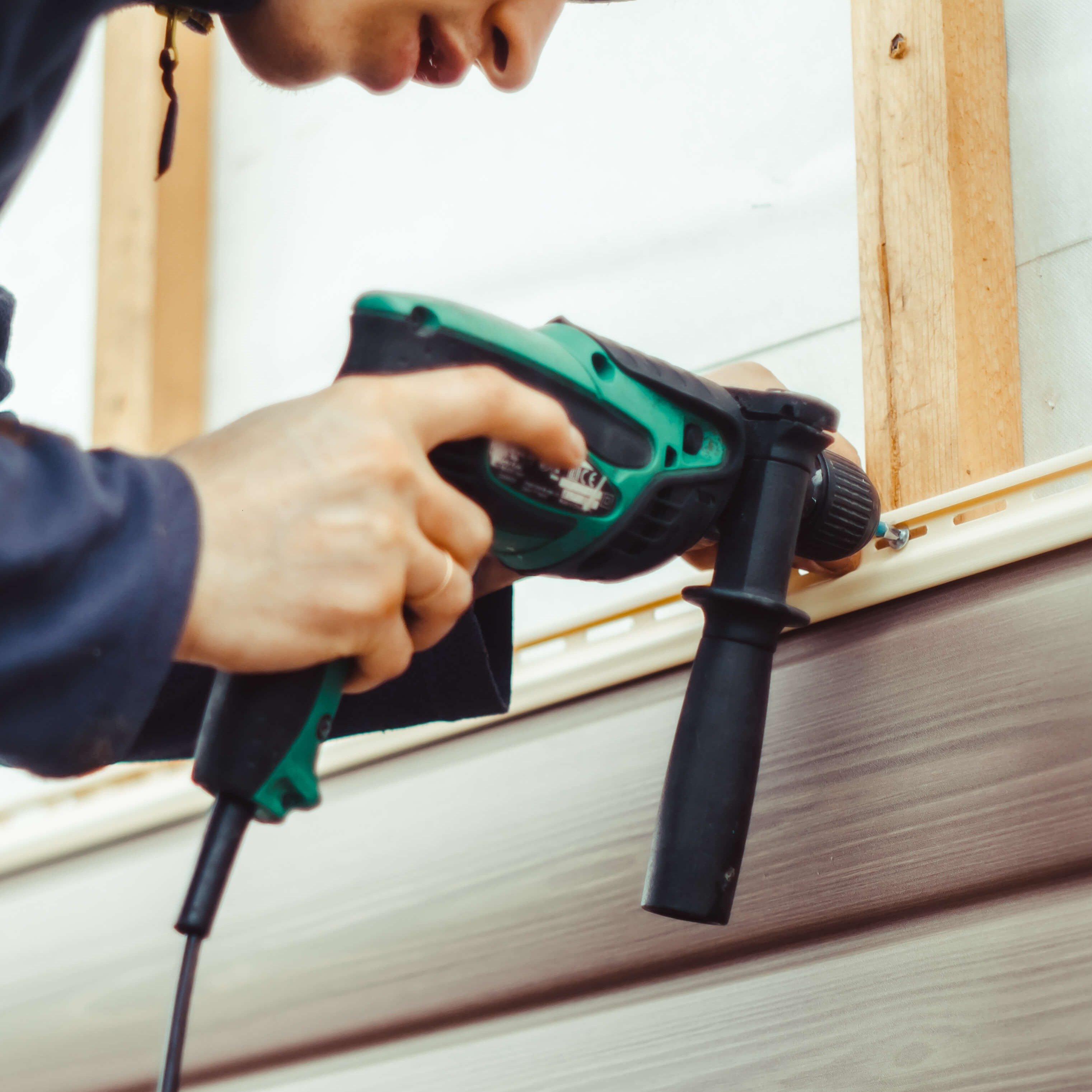 person-installing-vinyl-siding-1